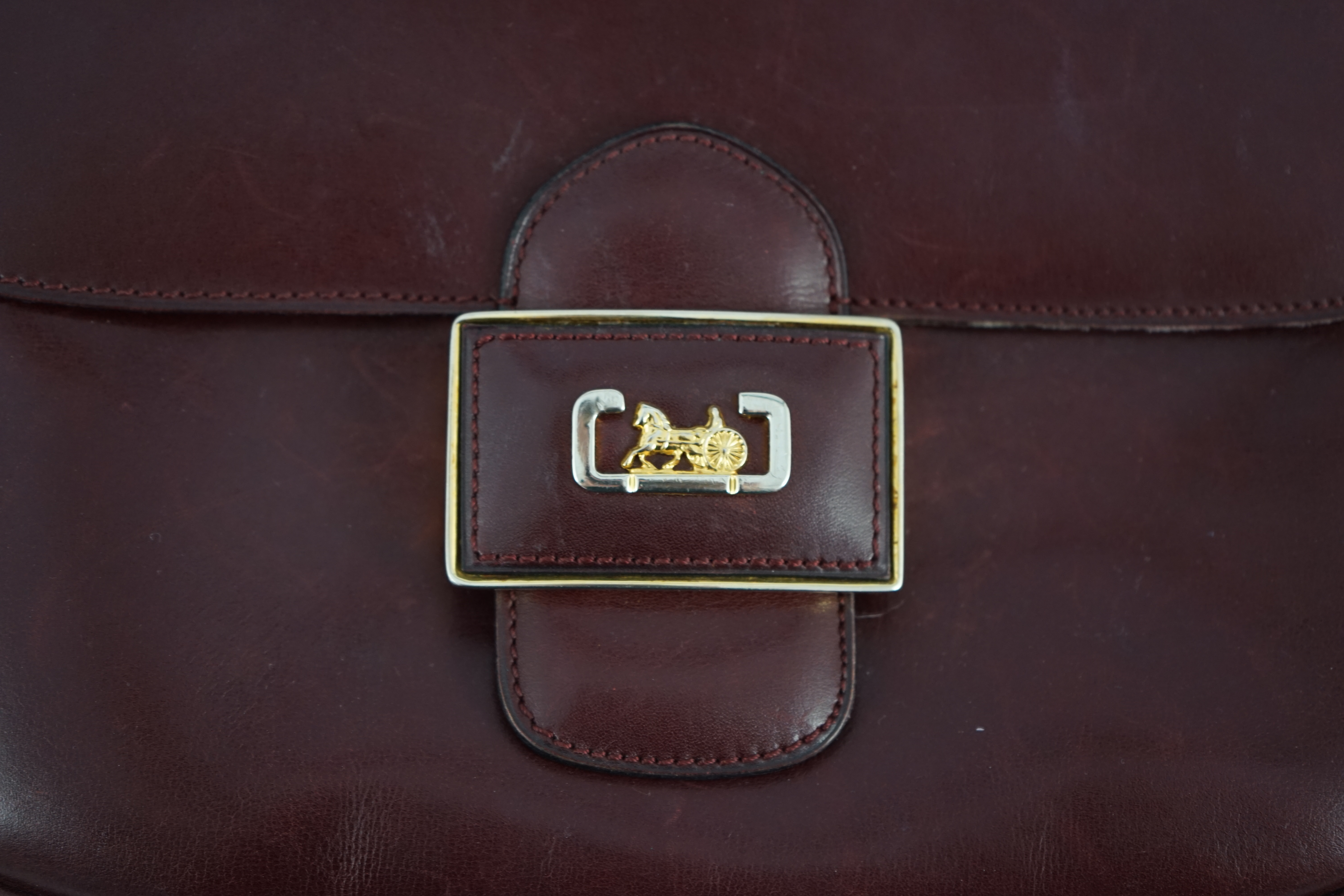 A vintage Celine horse carriage cargo flap burgundy leather shoulder bag, width 26cm, depth 3cm, height 18.5cm